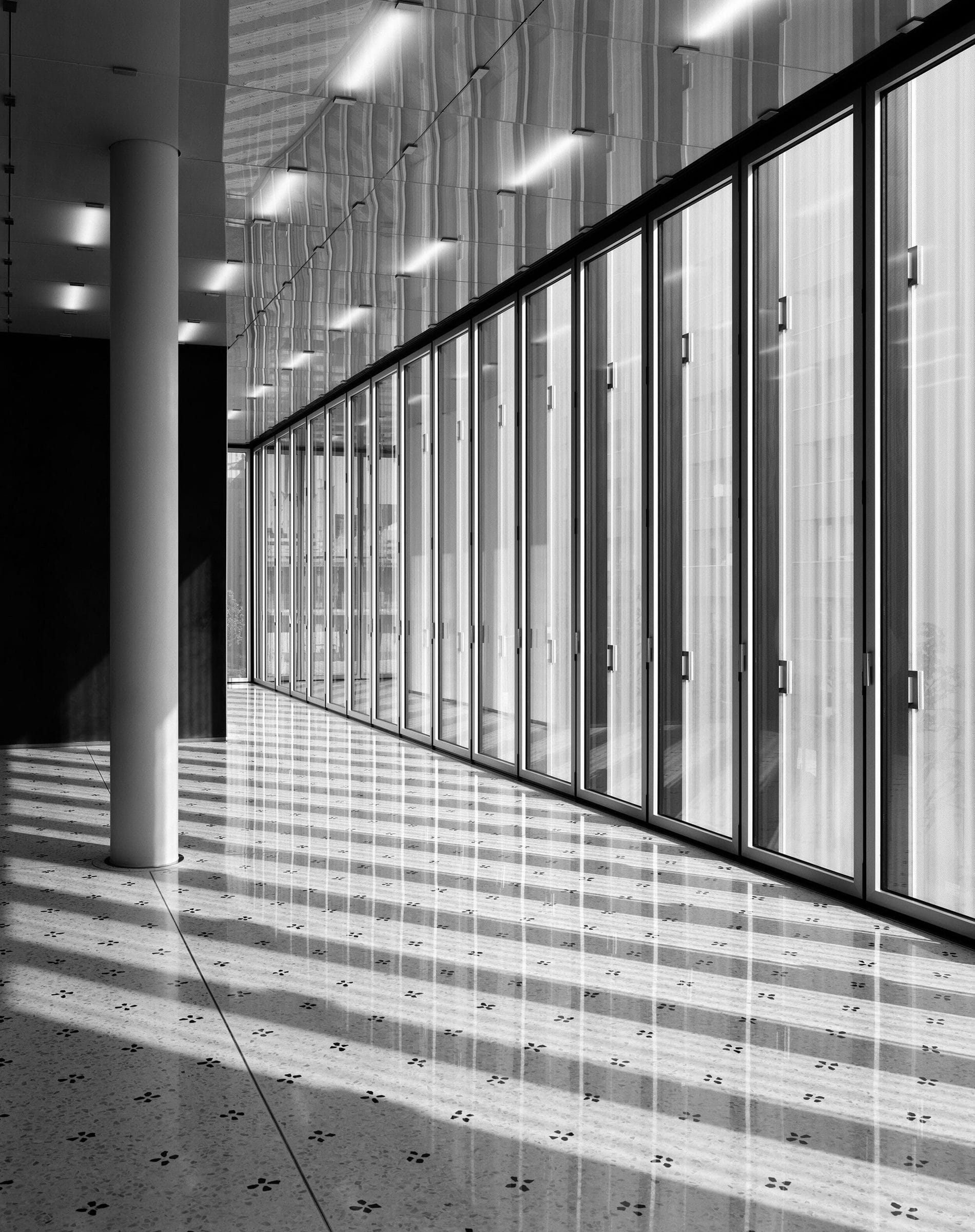 Luce e ombre attraverso la vetrata di un percorso interno